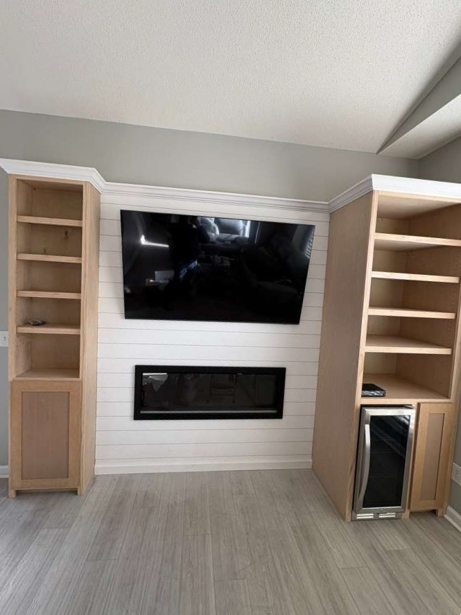 Custom TV wall with electric fireplace and built-in shelving, Conway SC